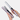 Hair straightener and curling iron held by a hand on a white background