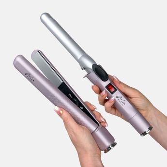 Hair straightener and curling iron held by a hand on a white background