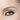 Close-up of a person's blue eye wearing Chanel's brown eyeliner