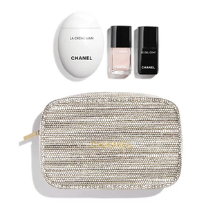 Chanel nail care set with cream, polish, top coat, and pouch on a white background