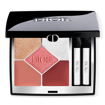 Dior makeup palette with five color swatches and two applicators on a white background