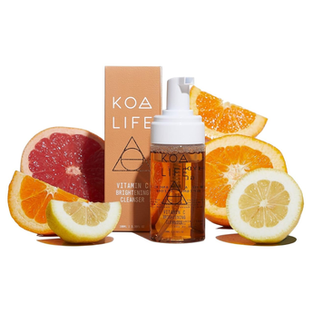 KOA LIFE skincare product with citrus fruits on a white background