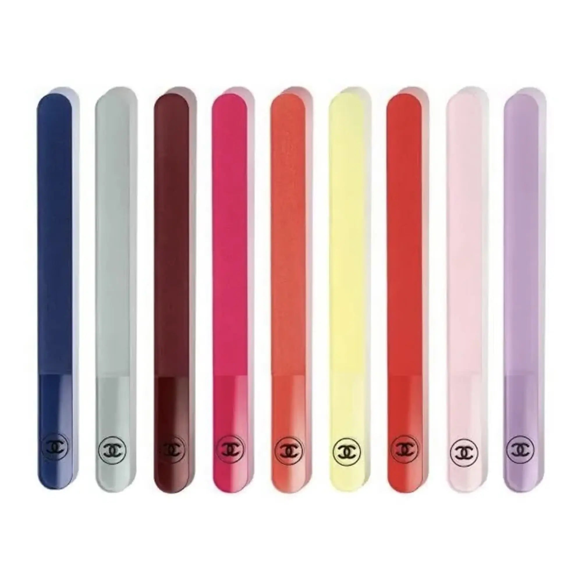 A set of nine Chanel color-coded nail files, displayed in a line, with a range of colors including blue, pink, red, yellow, and purple.