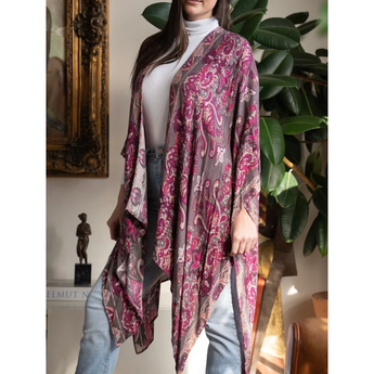 Woman wearing a patterned scarf in a room with decor elements.