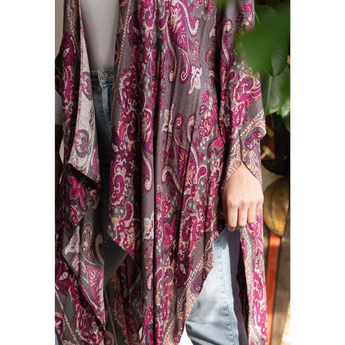 Person wearing a patterned scarf with a blurred background