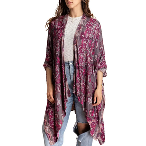 Woman wearing a patterned kimono over casual clothing on a white background
